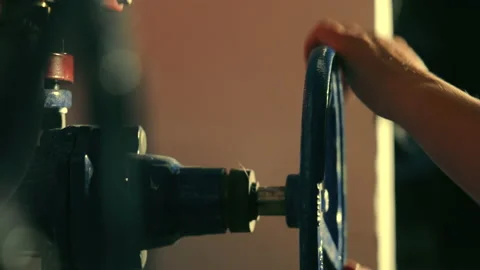 Gas supply overlap. Close up of engineer closes big industrial valve crane Stock Footage 169388352