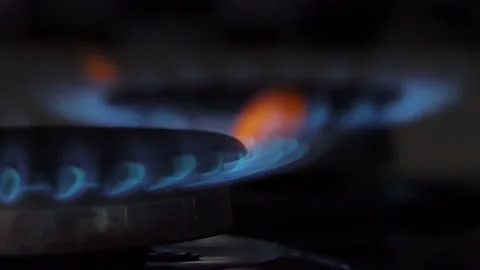 Gas switch on and lit on the Kitchen Stove appearing blue flame. Natural gas Stock Footage 194672048