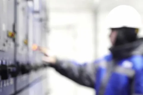 Gas worker presses buttons on the control panel of a gas treatment plant Stock Photos