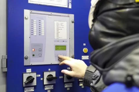 Gas worker presses buttons on the control panel of a gas treatment plant Stock Photos