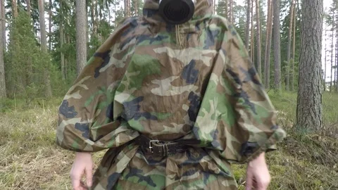 Gasmasked man walking at camera through the woods Stock Footage 146012519