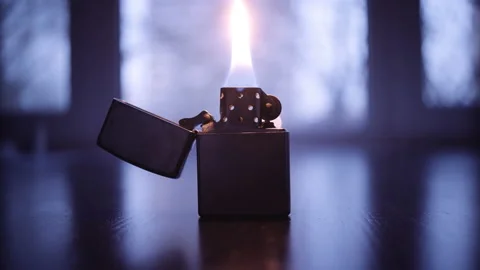 Gasoline lighter stands on the table with a burning wick Stock-Footage 153116891