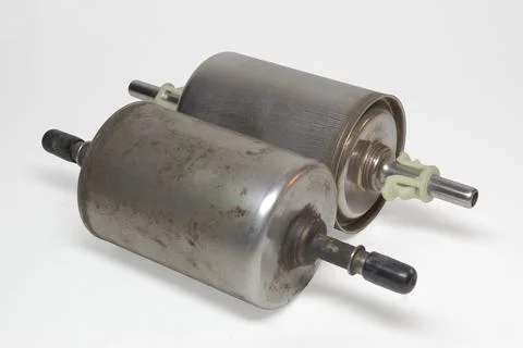Gasoline in-line filter pair, cap on fitting of dismantled one to prevent f.. Stock Photos
