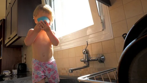 Gasping, choking concept. Pediatrics background. Toddler drinking water while Stock Footage 121535480
