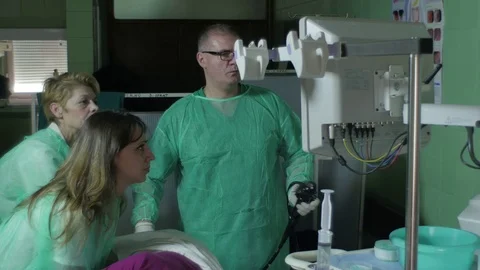 Gastroenterologist and nurses examine colon of patient, colonoscopy Stock Footage
