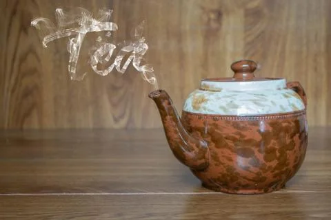 Gastronomic composition with teapot that forms the word tea with its hot stea Photos