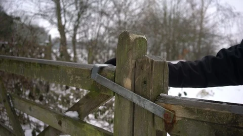 Gate being opened/unlatched to snow covered field, 4k, UK Stock Footage 86608189
