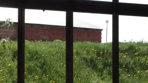 A gate in front of a brick building. Bobruisk Ruins Stock Footage 130140013