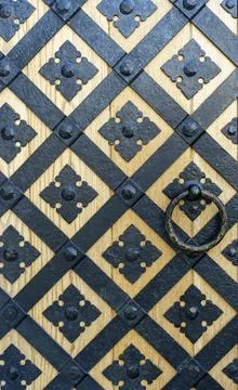 Gate with iron decorative pattern background. Medieval iron pattern on the door. Stock Photos