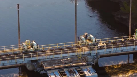 Gate Machinery and Service Platform Above Reflective Reservoir Water Stock-Footage 332624070