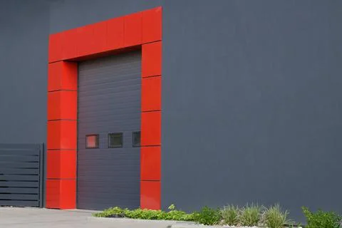 Gate or roller shutter with application to factory, warehouse or hangar. Stock Photos