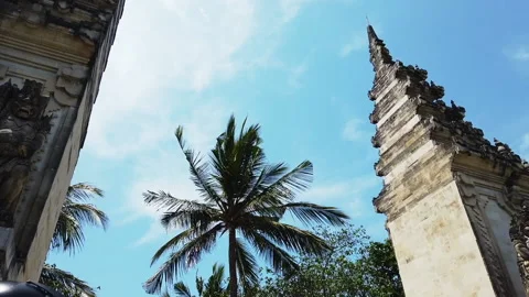 Gate, Palm tree and blue sky facing the sky and asian girl walking, Bali, HD Stock Footage 158589463