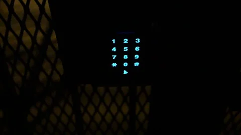 Gate security access keypad at night.  Blinking red light and blue lit keys Stock-Footage 102771781