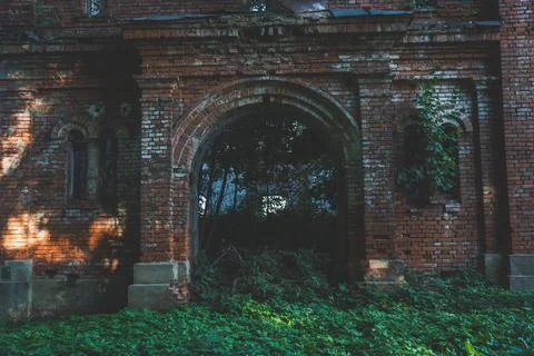 The gate to the stable. A ruined red brick stable. 19th century buildings Stock Photos