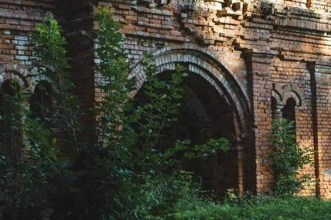 The gate to the stable. A ruined red brick stable. 19th century buildings Stock Photos