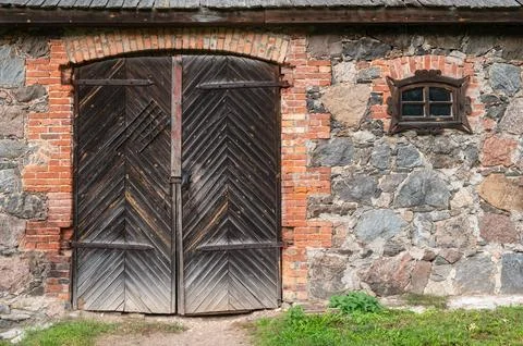 Gate to a stone barn. Stock Photos