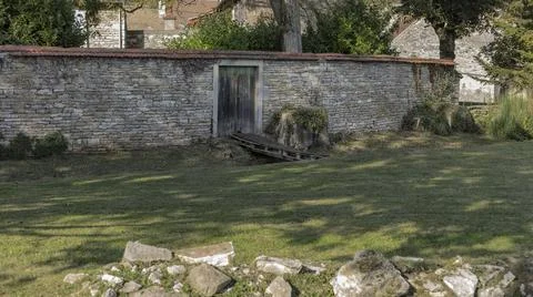 Gateway in a wall with  a small bridge Stock Photos