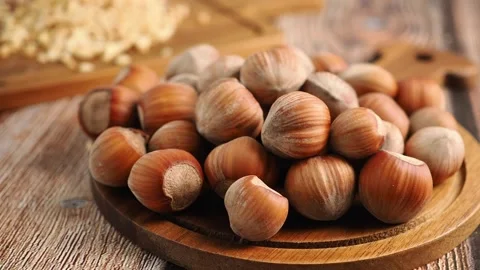 Gathering hazelnuts on a wooden table in a kitchen Stock Footage 341733373