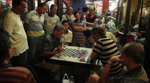 Gathering of men playing checkers or chess at night in Chinatown, Singapore Stock Footage 59896085