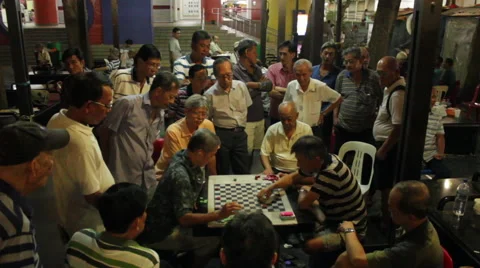 Gathering of men playing checkers or chess at night in Chinatown, Singapore Stock Footage 59896130
