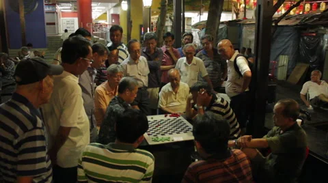 Gathering of men playing checkers or chess at night in Chinatown, Singapore Stock Footage 59896254