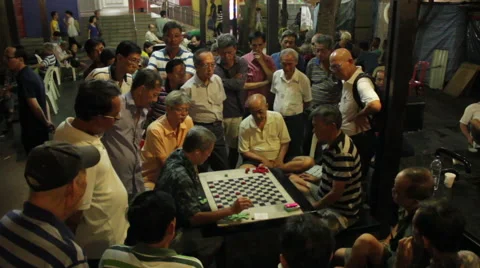 Gathering of men playing checkers or chess at night in Chinatown, Singapore Stock Footage 59896394