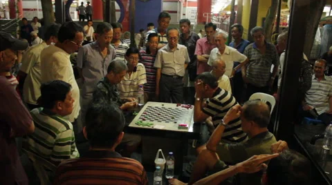 Gathering of men playing checkers or chess at night in Chinatown, Singapore Stock Footage 59896500