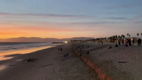 Gathering at sandy beach sunset on mountain coast Stock Footage 136340078