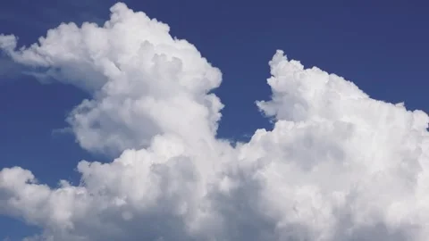 Gathering Of White Fluffy Clouds In Clear Blue Sky. Low Angle Shot Stock Footage 276651773