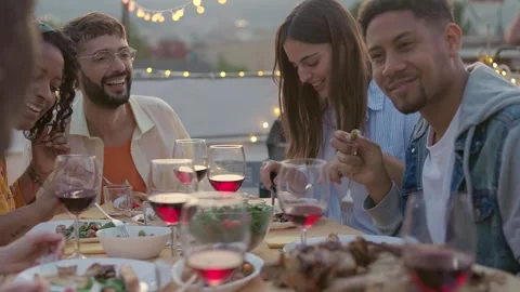 Gathering of young friends having fun at evening barbecue dinner party Stock Footage 246999978