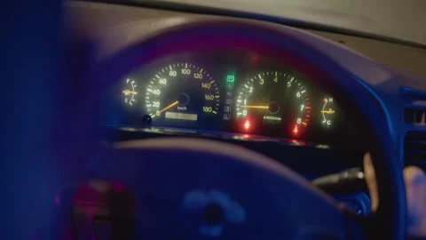 Gauges illuminate with flickering lights, Speedometer needle rises as lights 스톡 동영상 329454619