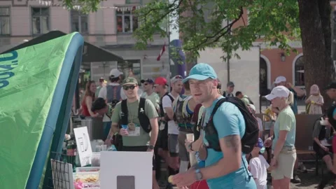 Gauja Trail by UTMB runners lining up for snacks after race Stock Footage 343971885