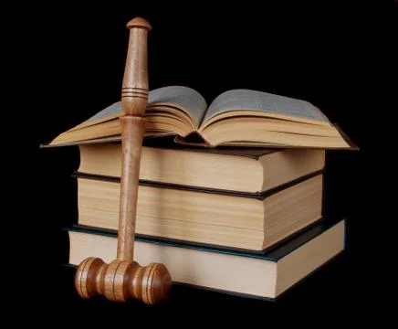 Gavel and stack of thick old books Stock Photos