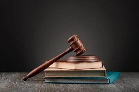 Gavel on top of a stack of books on dark background Stock Photos