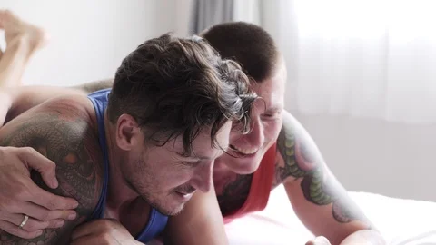 Gay couple in bed using phone. Enjoy watching phone. Stock Footage 105301583