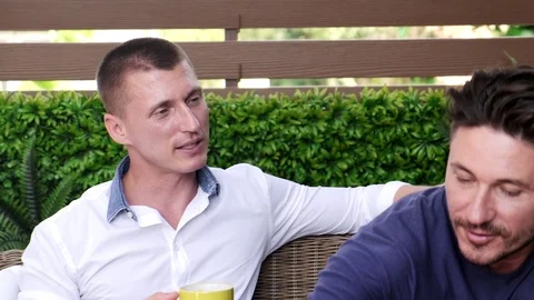 Gay couple having breakfast, talking, happy mood. Stock Footage 105294635