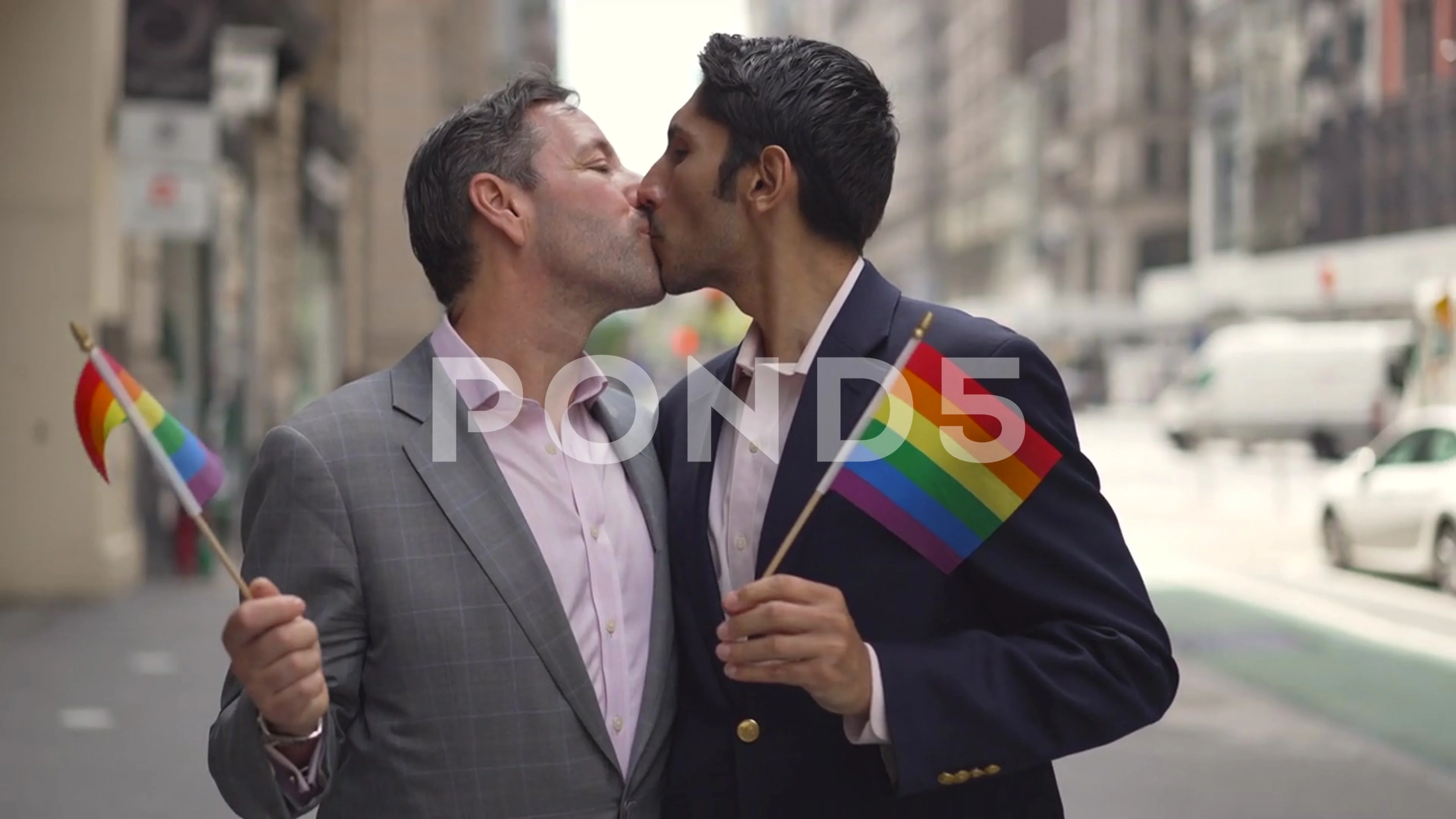 Gay couple same sex men kissing on New York City street