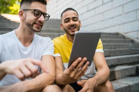 Gay couple using a digital tablet. Stock Photos
