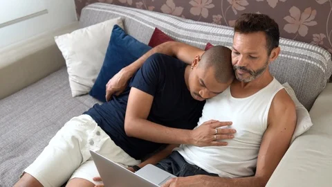 Gay Couple Using Laptop at Sofa Stock Footage 98626580