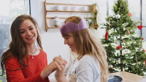 Gay Female Couple At Home Dancing In Kitchen As They Prepare Dinner On Christmas Stock Footage
