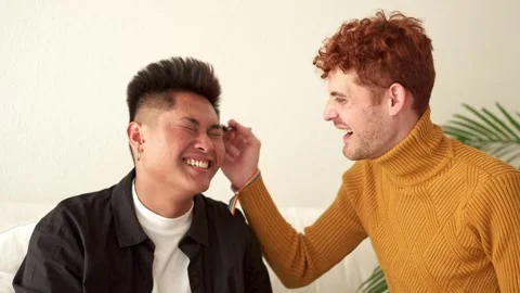 Gay man applying make up to her partner while smiling Video stock 243545196
