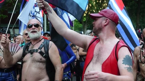 A gay man dances while waving a rainbow flag during the Madrid Pride Parade Stock Footage 339205488