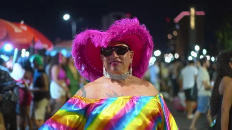 Gay non binary man in rainbow costume dance lgbt pride parade party. Lgbtq month Stock Footage 303498574