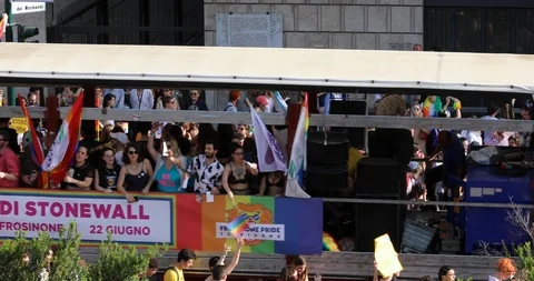 Gay pride, crowd of protesters parade with wagons. Stock Footage 109575327