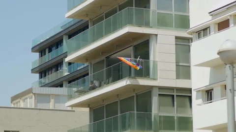 Gay Pride flag waving in the wind on an apartment building Stock Footage 110652194