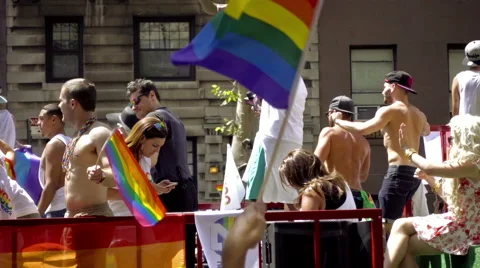 Gay Pride float and rainbow flags - LGBT Parade in NYC  Stock Footage 64957839