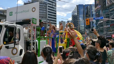 Gay pride float in parade viewed near religious protesters - 24fps 1080p Stock Footage 104118608