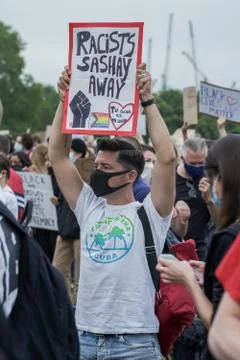 A Gay protester holding an anti racism banner in Hyde Park, London Stock Photos
