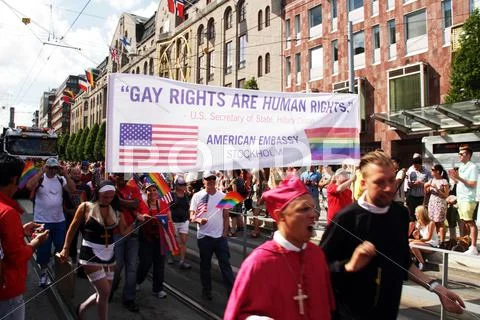 Gay rights are human rights banner with people dressed as religious figures. Stock Photos