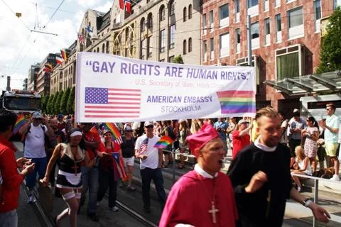 Gay rights are human rights banner with people dressed as religious figures. Stock Photos